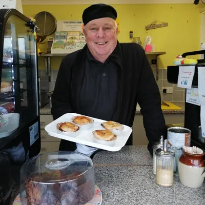 Nigel holding some pies