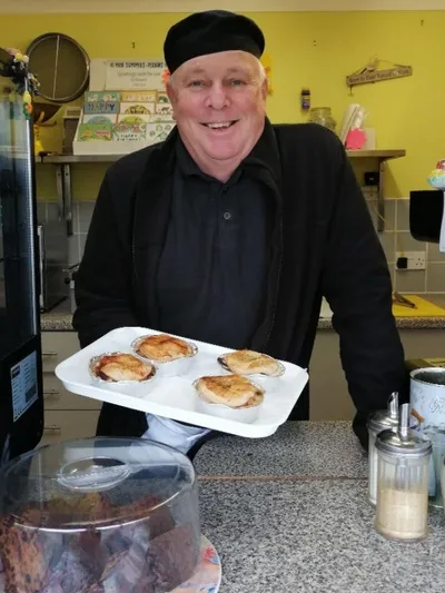 Nigel holding some pies